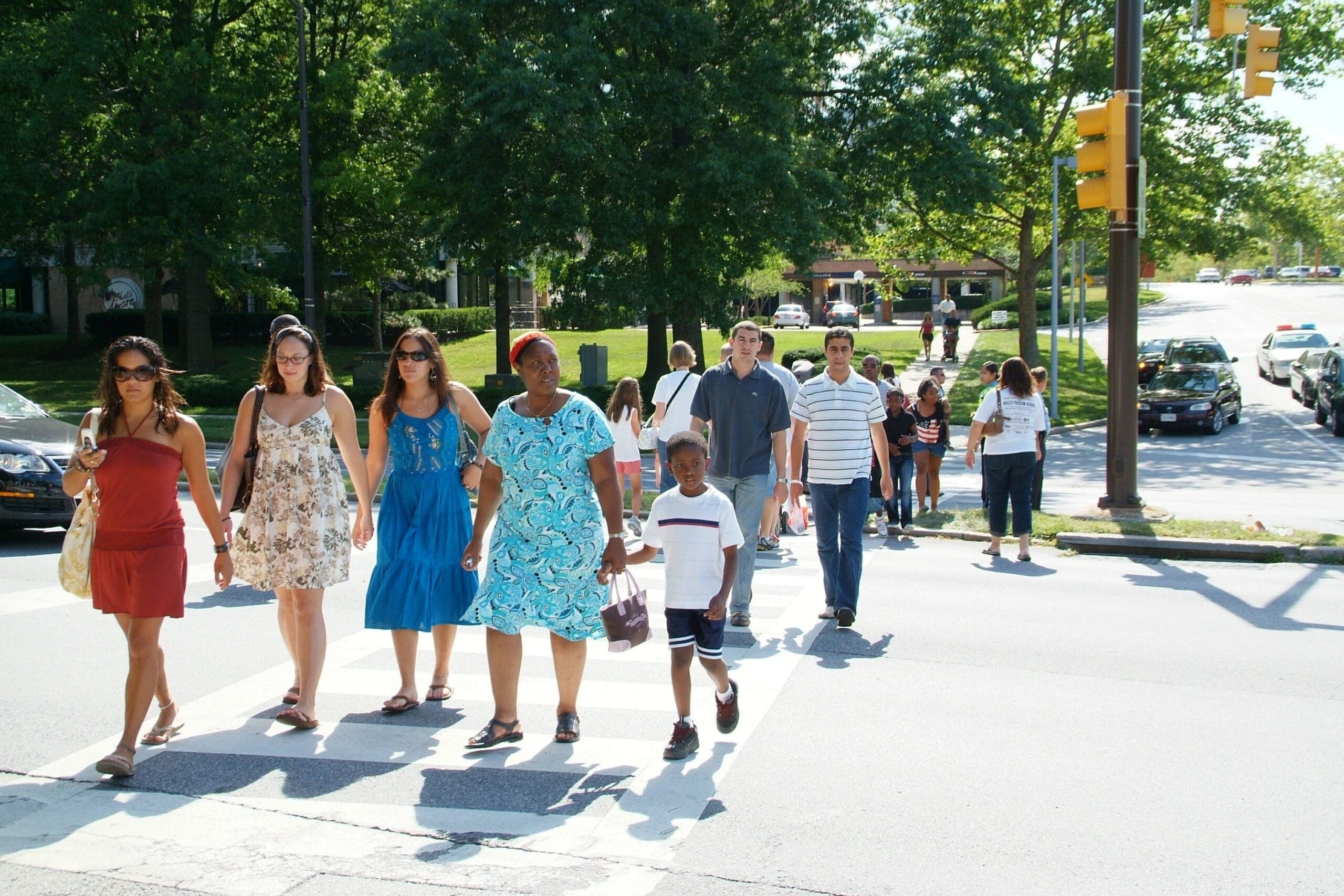 Walking-DT-Columbia-scaled A diverse group of people crosses the street on a marked and signalized crosswalk