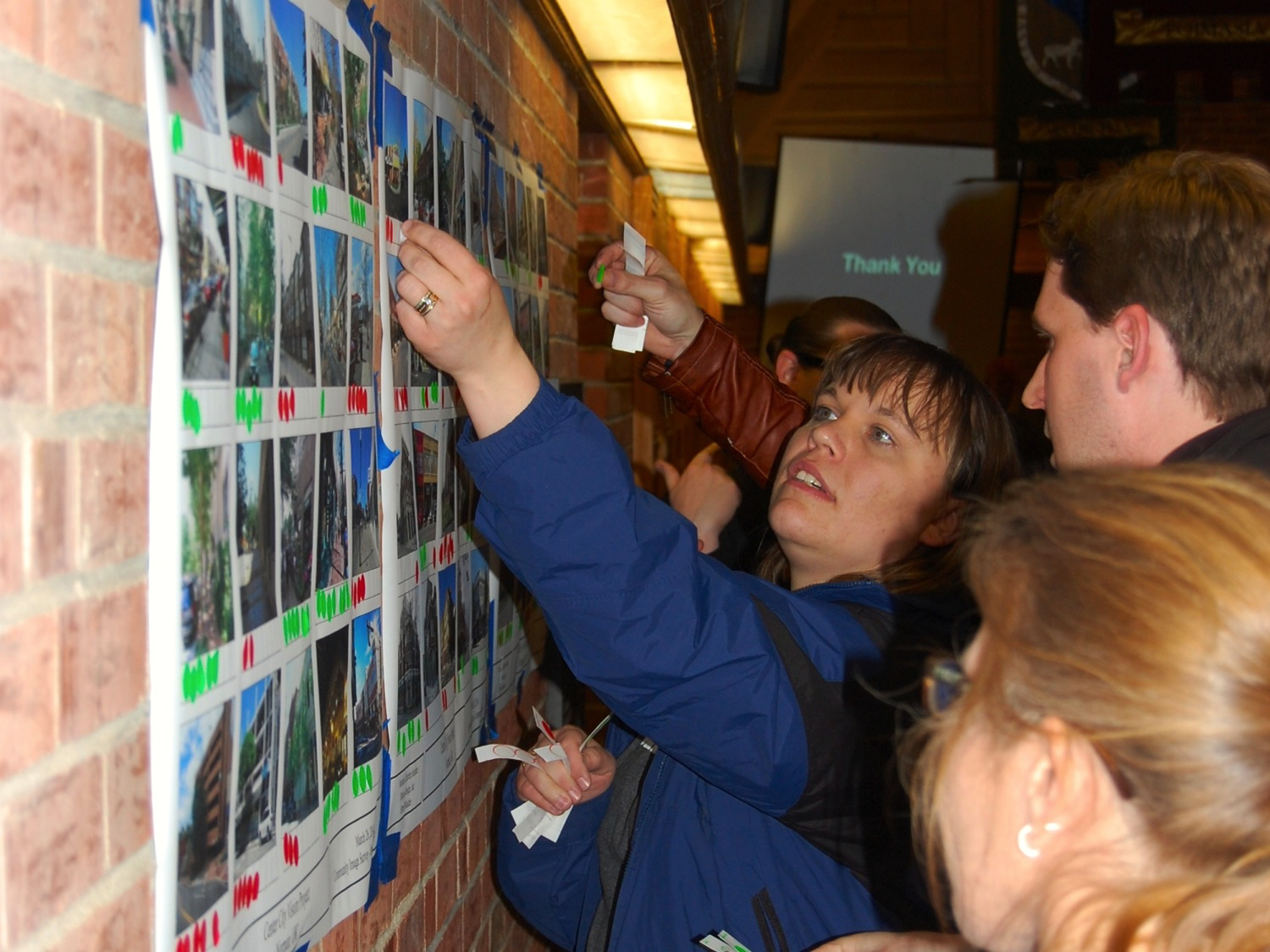 A charrette participant votes for the types of housing they would like to see in their neighborhood.