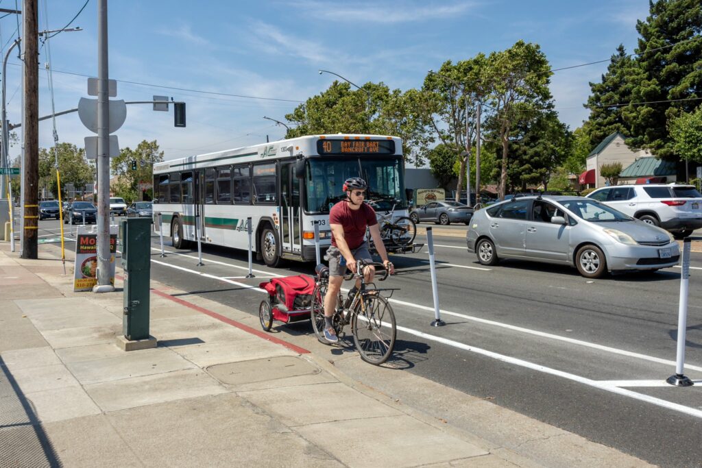 A bicycle rider waiting on a bicycle lane