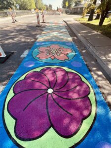 A mural of colored flowers is painted on the sidewalks as part of the Adaptive Streets project on College Avenue in Tempe, Arizona.