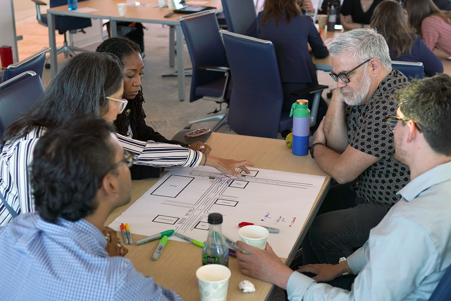 people strategizing at a table