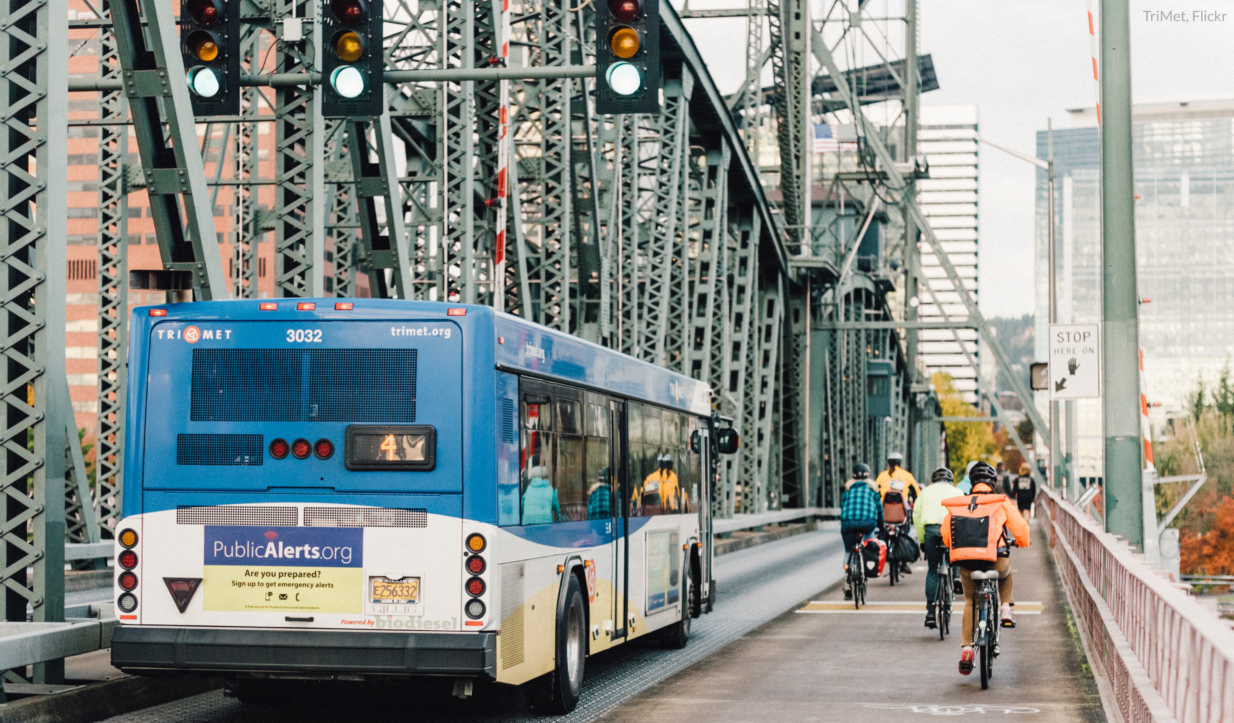 a bus drives alongside a gaggle of bikers