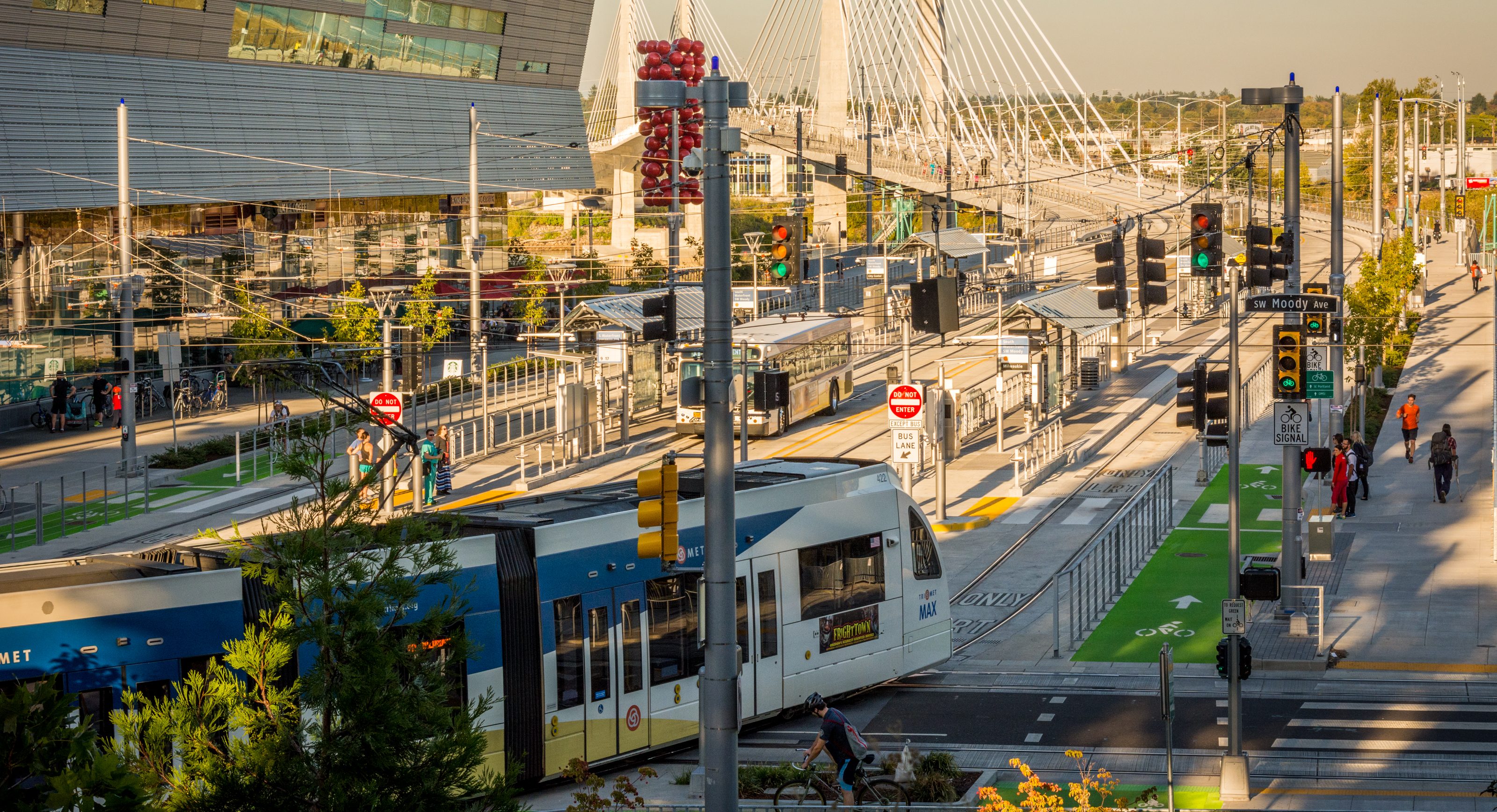 Pictured is the Tilikum Crossing Bridge in Portland, OR which serves buses and light rail and has bike baths and walkways for people.