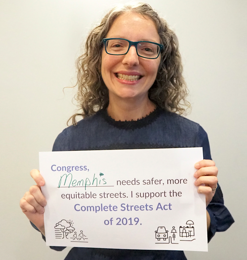 Sylvia holding a poster that reads, "Congress, Memphis needs safer more equitable streets. I support the Complete Streets Act of 2019."