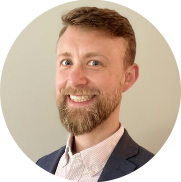 Chris McCahill's headshot, light brown hair and a beard with a collared shirt and blazer