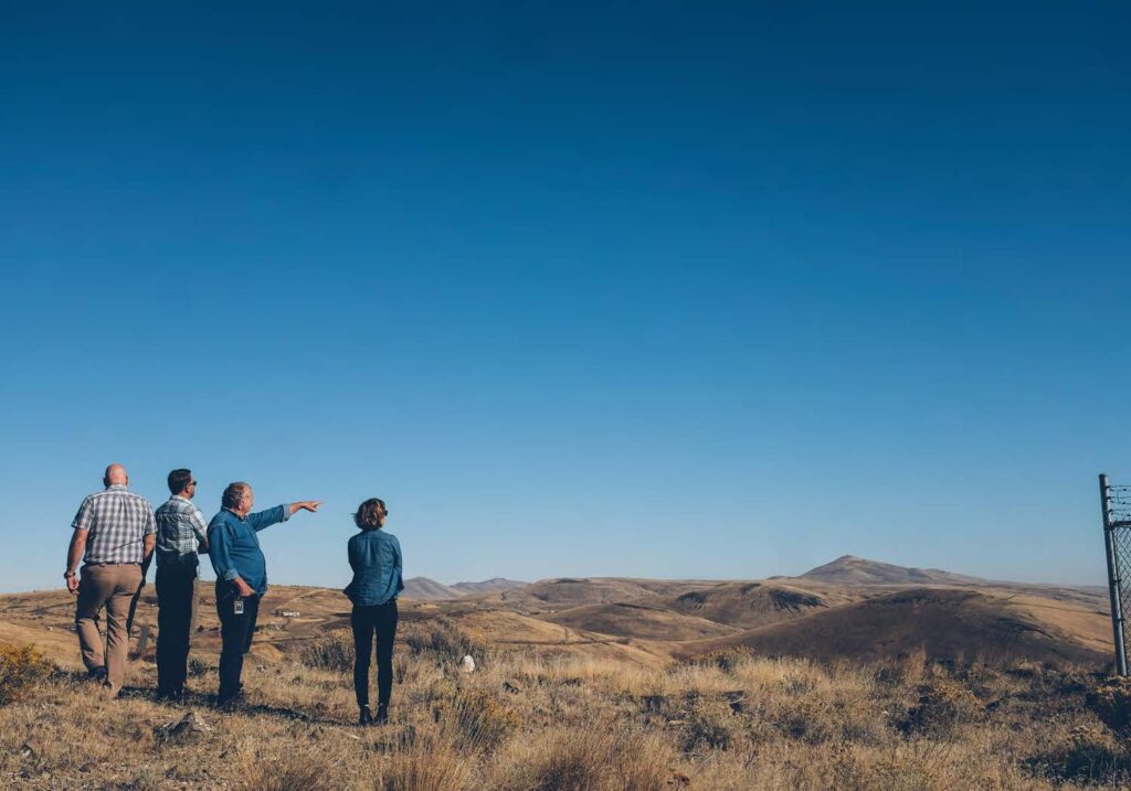 Image of four people overlooking a flat landscape scene in Washington State.