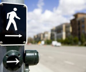 An Accessible Pedestrian Signal, which includes a tactile button that triggers audible alerts and vibrations to let people with sensory disabilities know when it is safe to cross the street