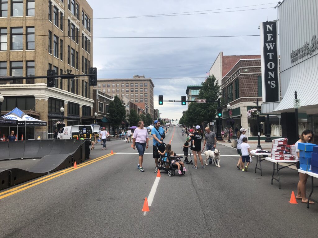 Parents, children, and dogs in the middle of a closed Joplin Main Street