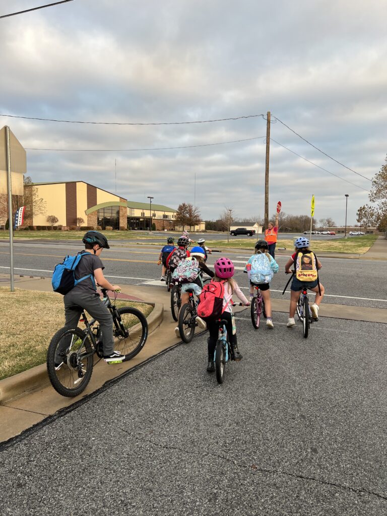 A group of children take a bike bus to school.