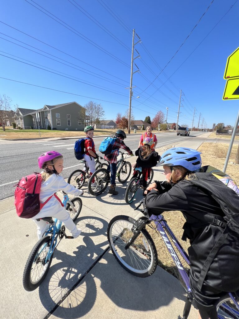 A group of children take a bike bus to school.