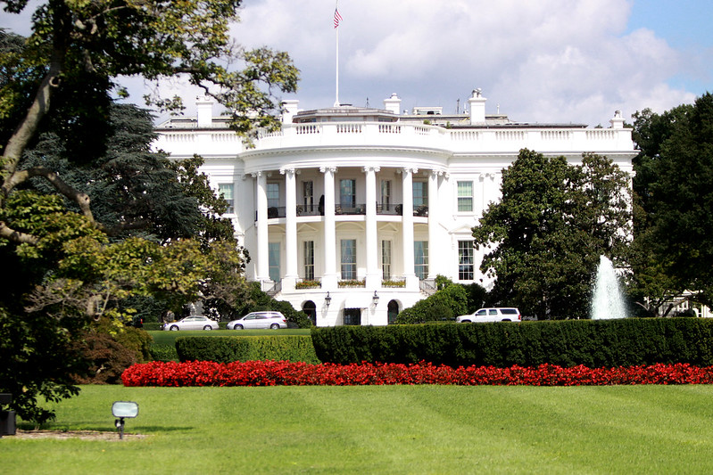 The south lawn of the White House includes a fountain ringed with red flowers