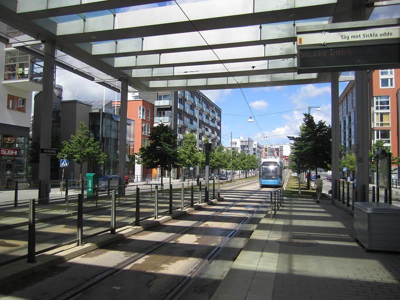 A streetcar travels between two apartment buildings