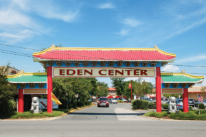 Photograph of a Vietnamese-style archway with brightly colored wood paneling welcoming visitors to the Eden Center
