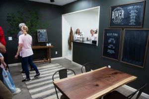 Customers arrive at the cozy River Blend Coffee Shop, where students are ready and waiting to serve them