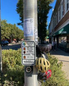A photo shows duct-taped “complimentary” bike helmets to street poles at Grand Blvd intersections, accompanied by a note from the City of St. Louis.