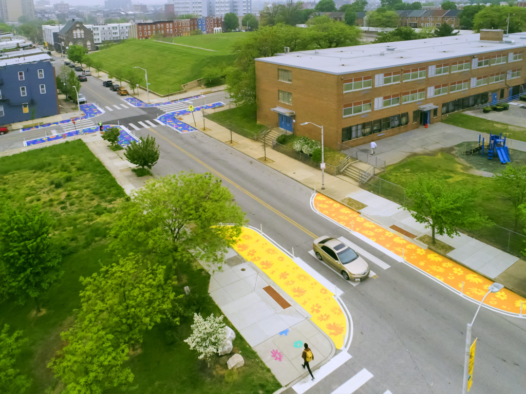Multiple intersections are brought to life with the addition of colorful painted bumpouts that decrease the distance pedestrians have to cross and alert drivers that pedestrians are present in this area.