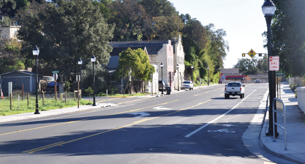 A painted bike lane lines a narrow road