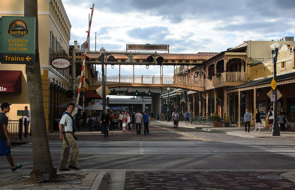 Pedestrians wait to cross the street in downtown Orlando