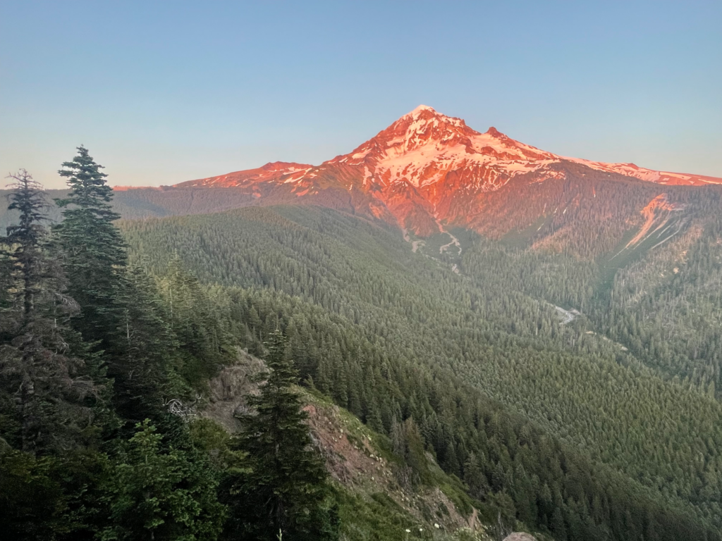 An orange mountain peak in front of a clear blue sky